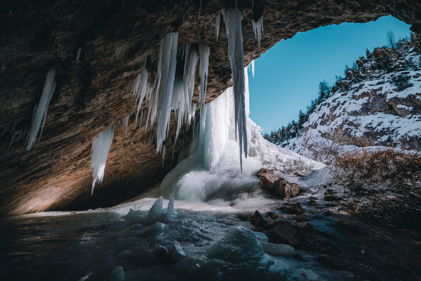 a cave with icicles on the top hanging down as spears